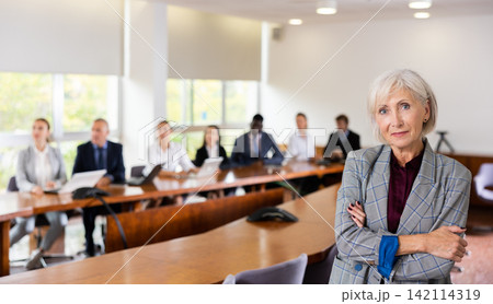 Portrait of positive senior businesswoman in meeting room Portrait of positive senior businesswoman in meeting room 142114319