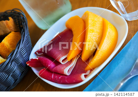 Sliced jamon with fresh juicy melon 142114587