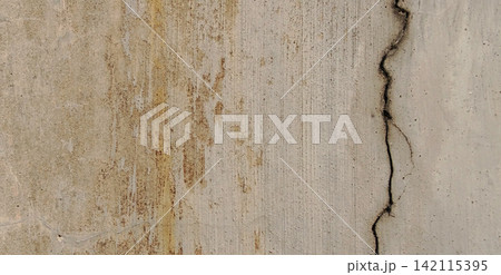 Weathered concrete wall with vertical cracks and rust stains. Weathered concrete wall with vertical cracks and rust stains. 142115395