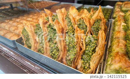 Pistachio Wrap Baklava in a bakery display case Pistachio Wrap Baklava in a bakery display case 142115525