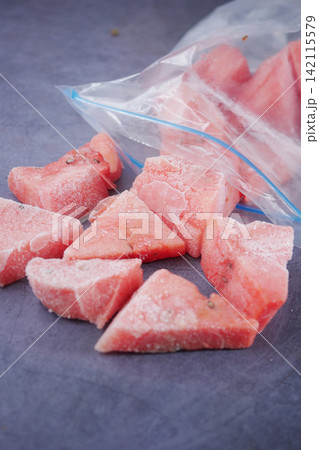 Frozen watermelon pieces in a plastic bag on a table Frozen watermelon pieces in a plastic bag on a table 142115579