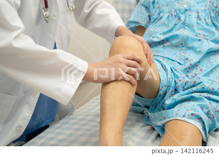 Doctor checking Asian elderly woman patient knee replacement surgery in hospital. Doctor checking Asian elderly woman patient knee replacement surgery in hospital. 142116245