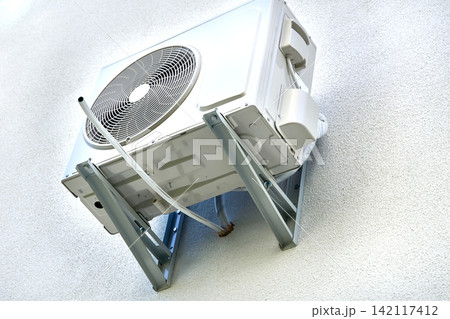 Air condition.Outdoor conditioner cooling appliance on plastered wall Air condition.Outdoor conditioner cooling appliance on plastered wall 142117412