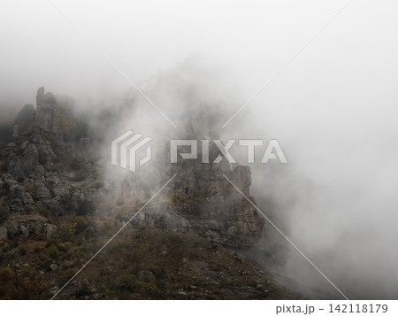 Minimalist moody mountain background with foggy rocky texture and copy space Minimalist moody mountain background with foggy rocky texture and copy space 142118179