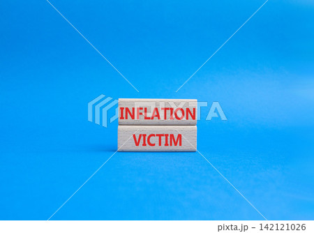 Inflation Victim symbol. Wooden blocks with words Inflation Victim. Beautiful blue background. Business and Inflation Victim concept. Copy space. 142121026