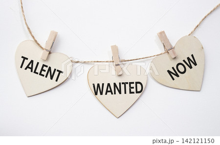 Talent Wanted Now text on wooden heart tags hanging on rope with clothespins over white background. Recruitment and talent acquisition concept with copy space. Talent Wanted Now text on wooden heart tags hanging on rope with clothespins over white background. Recruitment and talent acquisition concept with copy space. 142121150