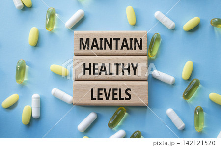MAINTAIN HEALTHY LEVELS symbol. Concept words MAINTAIN HEALTHY LEVELS on wooden blocks. Beautiful blue background with pills. Healthcare and MAINTAIN HEALTHY LEVELS concept. Copy space. 142121520