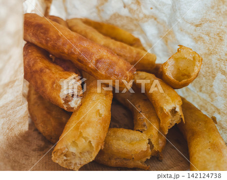 Traditional Spanish Churros in Paper Bag Close Up Traditional Spanish Churros in Paper Bag Close Up 142124738