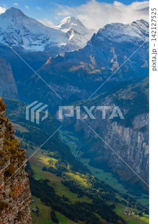 Swiss Alps Switzerland snow mountain peaks of Breithorn range rising above deep valley under blue sky with clouds Swiss Alps Switzerland snow mountain peaks of Breithorn range rising above deep valley under blue sky with clouds 142127525