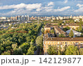 View of a city skyline with greenery and buildings during daytime under partially cloudy sky 142129877