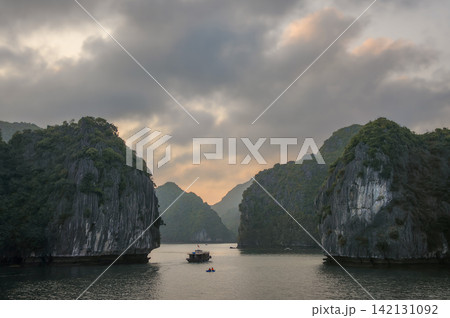 Natural scenery of Halong Bay in Vietnam with a small boat and a kayak Natural scenery of Halong Bay in Vietnam with a small boat and a kayak 142131092