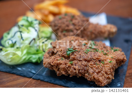 Fried chicken served on plate Fried chicken served on plate 142131401