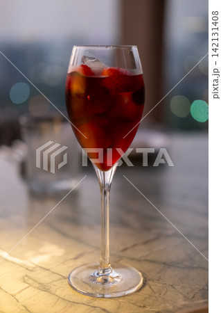 Close up view of red cocktail on the table with bokeh background 142131408