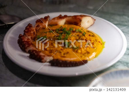Grilled octopus leg served with creamy spiced potato espuma and rich chorizo sauce Grilled octopus leg served with creamy spiced potato espuma and rich chorizo sauce 142131409