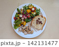 Balanced Harvard plate with leafy salad, tomatoes, beans, cheese, bread and sliced meat, combining protein, carbohydrates, healthy fats and fiber 142131477