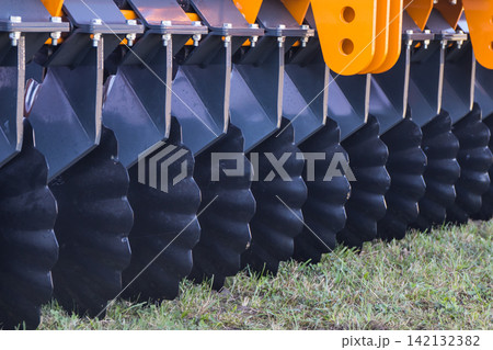 Part of agricultural disk harrow. Concept of modern technology in agriculture Part of agricultural disk harrow. Concept of modern technology in agriculture 142132382