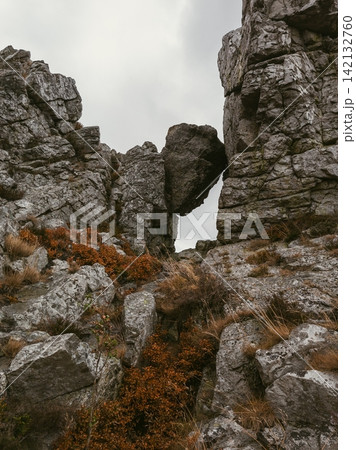 Suspended Rock Wedged Between Mountain Boulders Suspended Rock Wedged Between Mountain Boulders 142132760