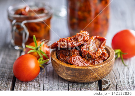 Sun-Dried Tomatoes in Olive Oil in a Rustic Bowl With Fresh Tomatoes and Preserved Jars Sun-Dried Tomatoes in Olive Oil in a Rustic Bowl With Fresh Tomatoes and Preserved Jars 142132826
