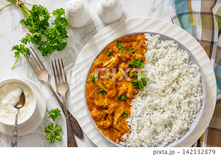 Spiced chicken curry with cooked long grain rice Spiced chicken curry with cooked long grain rice 142132879