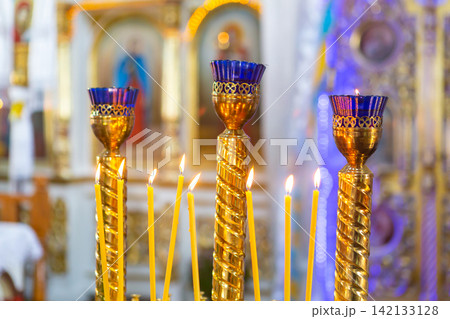 candles from natural wax burn in the church 142133128