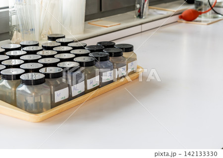 labeled water sample plastic bottles in laboratory labeled water sample plastic bottles in laboratory 142133330