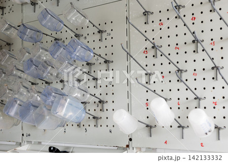 numbered pegboard rack with plastic containers in laboratory 142133332