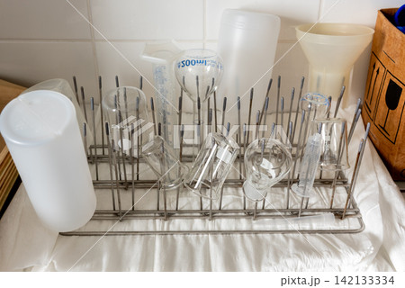 laboratory glassware drying on metal rack in science lab laboratory glassware drying on metal rack in science lab 142133334