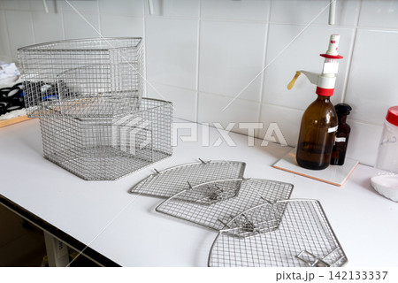metal wire baskets and mesh trays in laboratory workspace metal wire baskets and mesh trays in laboratory workspace 142133337