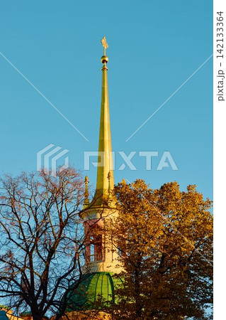 Spire of the Engineering castle across the Moika River with a beautiful embankment on a sunny autumn evening, Russia, St.Petersburg Spire of the Engineering castle across the Moika River with a beautiful embankment on a sunny autumn evening, Russia, St.Petersburg 142133364