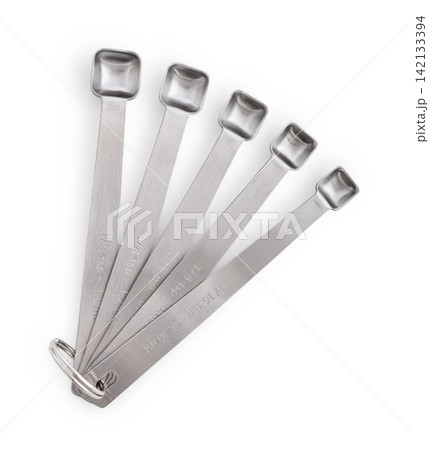 Five stainless steel measuring spoons of different sizes isolated on a white 142133394