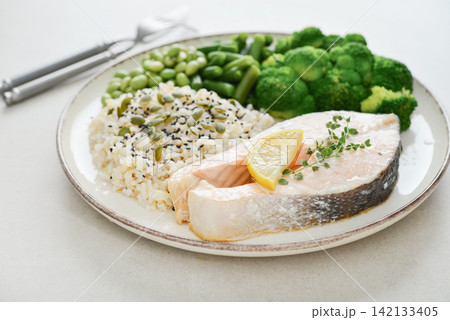 Balanced healthy meal with baked salmon with brown rice and vegetables Balanced healthy meal with baked salmon with brown rice and vegetables 142133405
