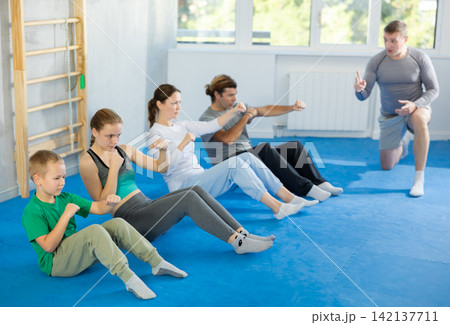Family pupils performs exercises to strengthen press and improve accuracy of hands Family pupils performs exercises to strengthen press and improve accuracy of hands 142137711