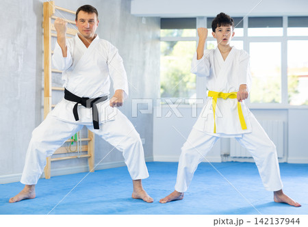 Man and boy teenager train karate technique 142137944