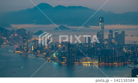 Hong Kong Aug 5 2026 Kowloon skyline and ICC tower against distant mountains Hong Kong Aug 5 2026 Kowloon skyline and ICC tower against distant mountains 142138384