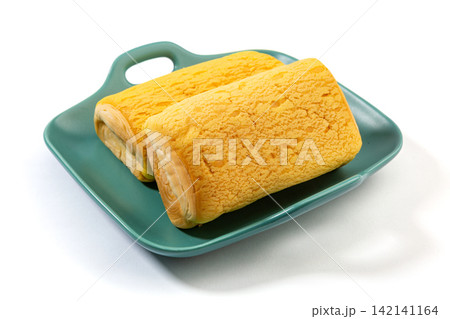 soft Custard Cream Swiss Rolls Served On Green Ceramic Plate soft Custard Cream Swiss Rolls Served On Green Ceramic Plate 142141164