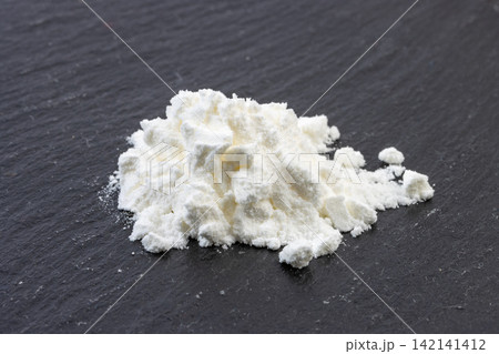 white Cornstarch Powder in Ceramic Bowl with Wooden Spoon white Cornstarch Powder in Ceramic Bowl with Wooden Spoon 142141412