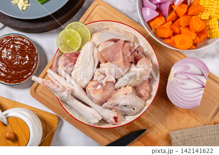 chopped Raw Chicken Pieces with Wings and Feet chopped Raw Chicken Pieces with Wings and Feet 142141622