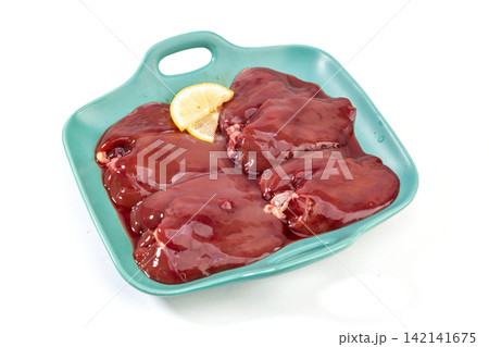 raw Chicken Livers on Plate with Lettuce 142141675