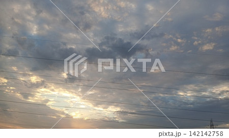 Dramatic Evening Cloudscape with Golden Sunlight Breaking Through Dramatic Evening Cloudscape with Golden Sunlight Breaking Through 142142758