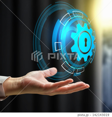 A hand holding a glowing blue digital hologram of a security gear with a keyhole, representing cybersecurity. Concept of Encrypted Data Flow 142143019