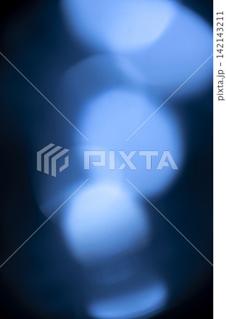 Abstract background featuring soft, out-of-focus glowing blue bokeh lights on a dark backdrop. Abstract blue background Abstract background featuring soft, out-of-focus glowing blue bokeh lights on a dark backdrop. Abstract blue background 142143211