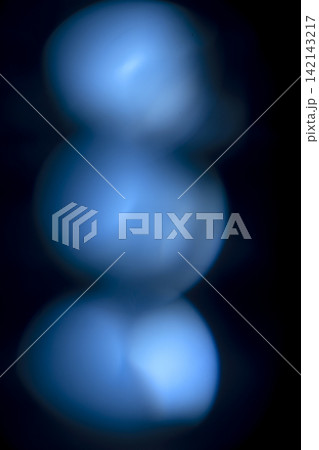 Abstract out of focus blue bokeh lights against a black background. Abstract blue background Abstract out of focus blue bokeh lights against a black background. Abstract blue background 142143217