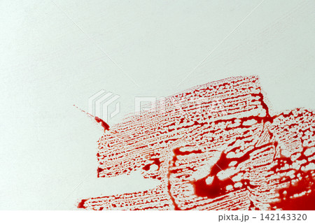 Red blood splatter and smears on a white surface, suitable for horror, crime scene, or forensic concepts. Halloween concept 142143320