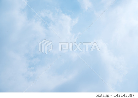 Serene light blue sky with soft, wispy white clouds, creating a peaceful and airy background. Sky or natural background Serene light blue sky with soft, wispy white clouds, creating a peaceful and airy background. Sky or natural background 142143387