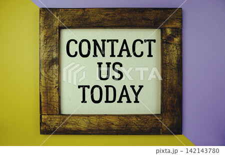 Contact Us Today text written on wooden frame on Contact Us Today text written on wooden frame on 142143780