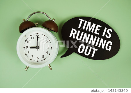 Time is Running Out text on speech bubble with alarm clock on green background Time is Running Out text on speech bubble with alarm clock on green background 142143840