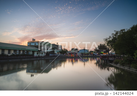 Sunset over a tranquil pond in Tainan, Taiwan Sunset over a tranquil pond in Tainan, Taiwan 142144024