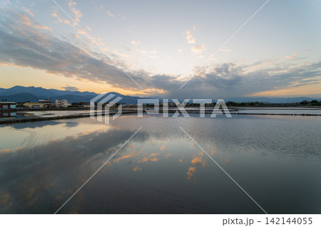 Sunset over flooded rice paddies in Yilan, Taiwan Sunset over flooded rice paddies in Yilan, Taiwan 142144055