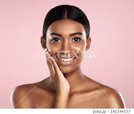 Portrait, beauty and Indian woman with cosmetics, skincare or dermatology on pink studio background. Face, person or model with healthy skin, makeup or shine with vibrant glow or wellness with luxury 142144157