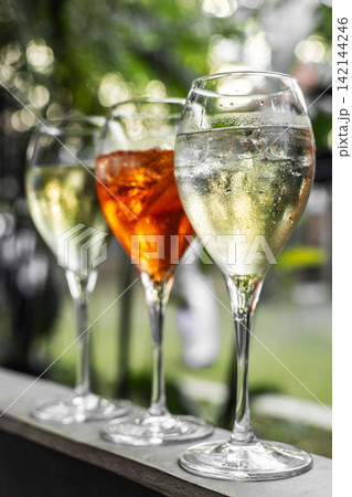 different iced spritzer wine cocktail drinks at outdoor garden bar party on sunny day 142144246